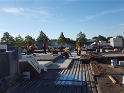 Contractors repairing roof