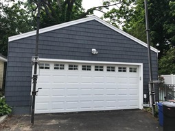 A garage with new, dark blue siding