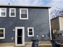 Completed dark blue vinyl siding on a home