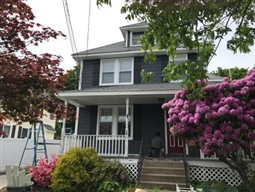 Beautiful new dark blue siding on a home.